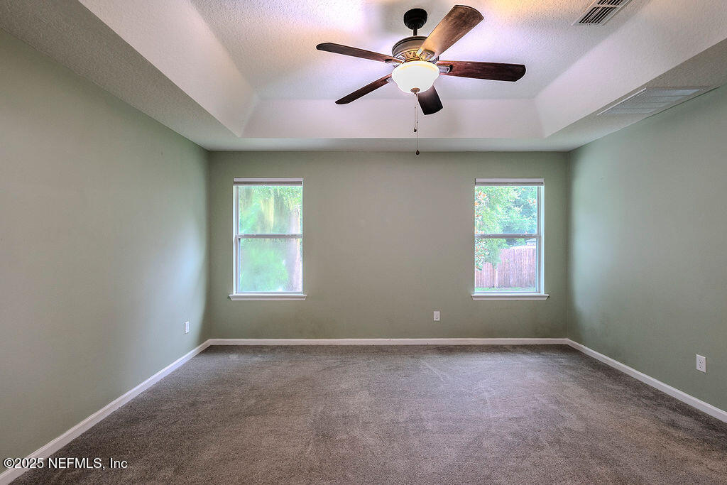 348 Auburn Oaks Road East Jacksonville, FL 32218 - Photo 16 of 30 an empty room with a window and a ceiling fan