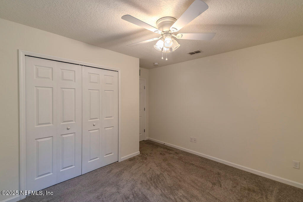 348 Auburn Oaks Road East Jacksonville, FL 32218 - Photo 26 of 30 an empty room with chandelier fan