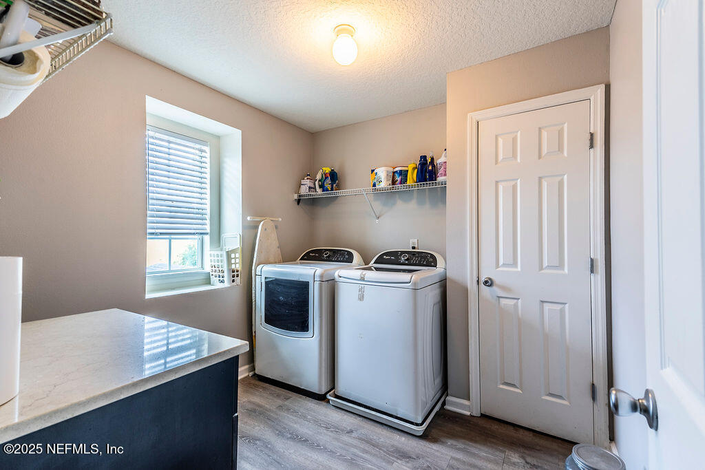 348 Auburn Oaks Road East Jacksonville, FL 32218 - Photo 28 of 30 a view of a kitchen with fridge and wooden floor