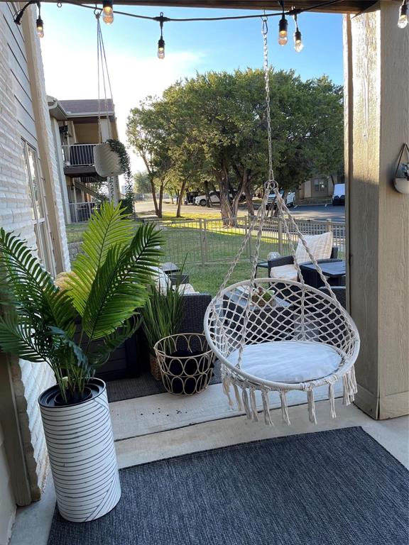 3063 Hells Gate Loop, Unit 23 Strawn, TX 76475 - Photo 23 of 36 a view of a wooden deck with chairs and potted plants