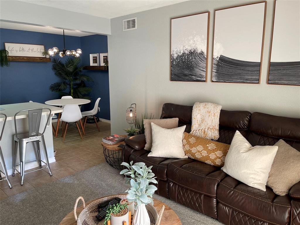 3063 Hells Gate Loop, Unit 23 Strawn, TX 76475 - Photo 3 of 36 a living room with furniture flowerpot and a potted plant