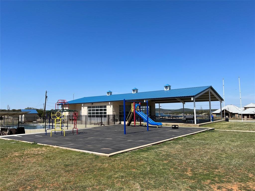 3063 Hells Gate Loop, Unit 23 Strawn, TX 76475 - Photo 33 of 36 a view of a swimming pool with lawn chairs