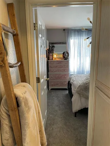 a bedroom with a bed and a mirror