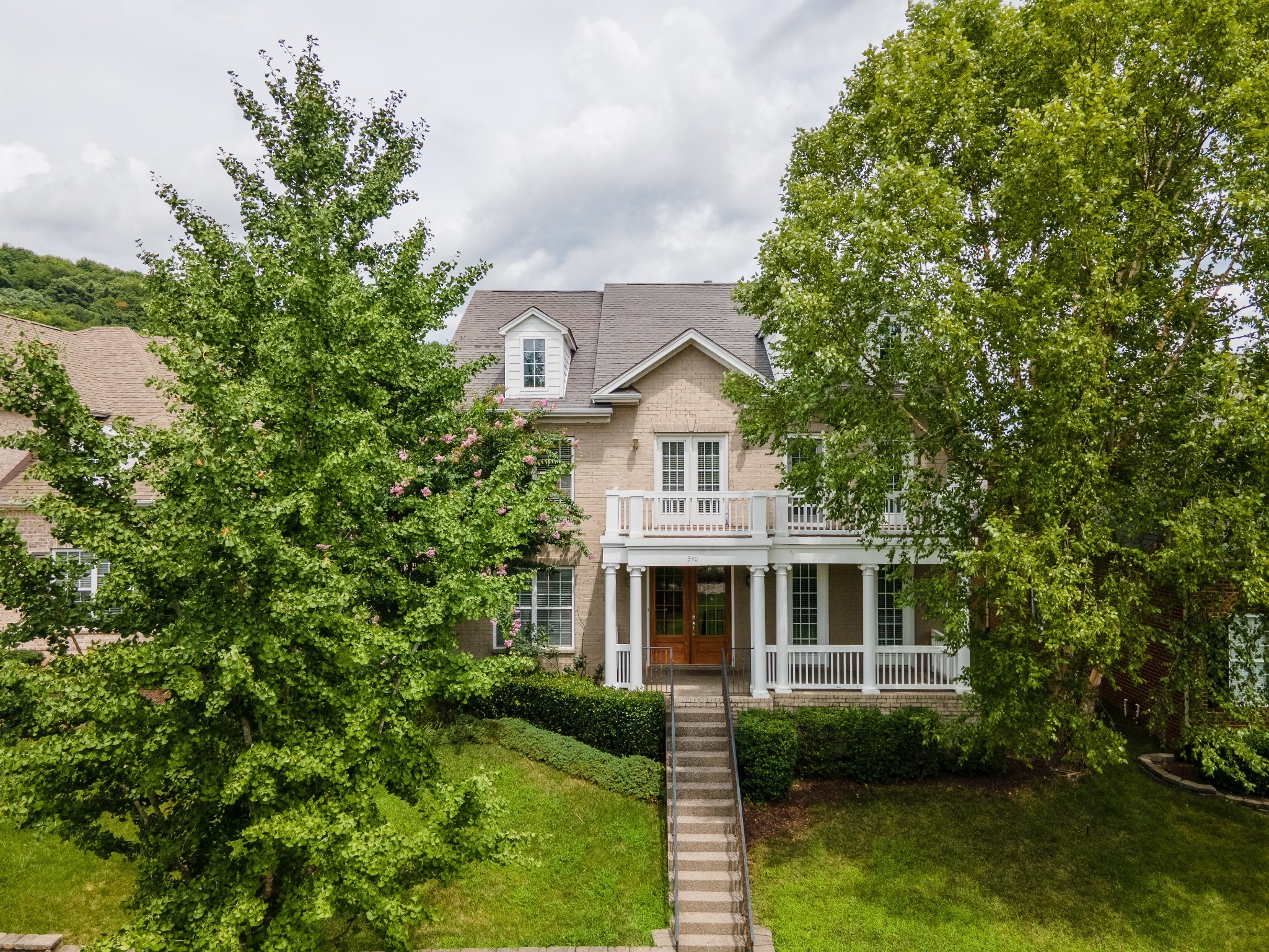 a view of house with garden space and a tree