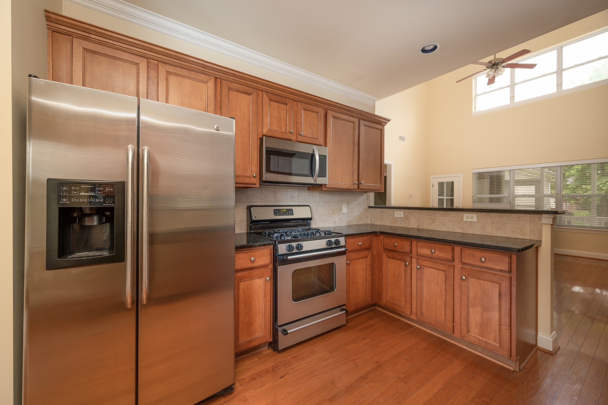 340 Wandering Circle Franklin, TN 37067 - Photo 18 of 51 a kitchen with stainless steel appliances granite countertop a refrigerator a sink and a stove