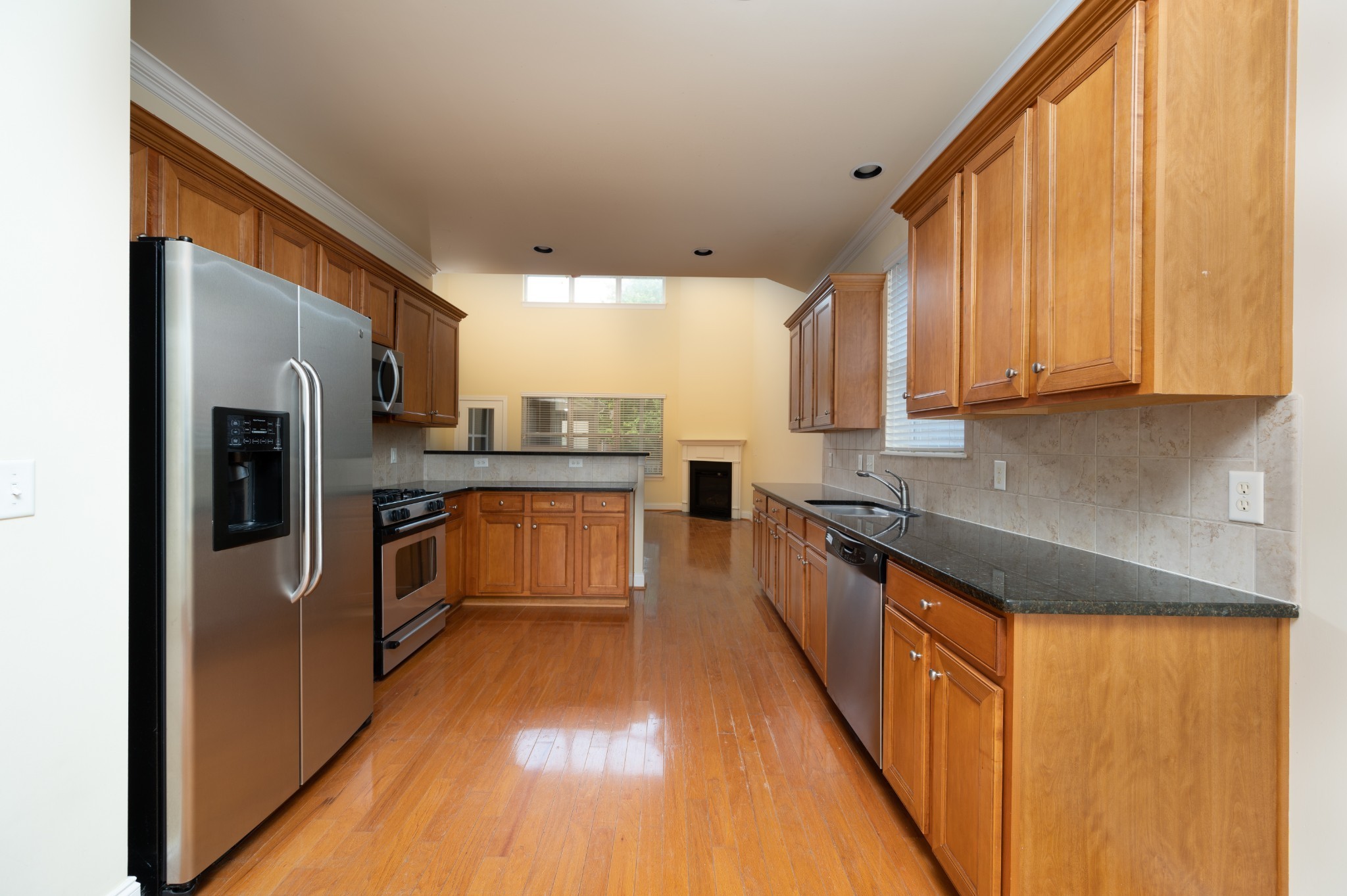 340 Wandering Circle Franklin, TN 37067 - Photo 19 of 51 a kitchen with stainless steel appliances granite countertop a stove a sink and a refrigerator