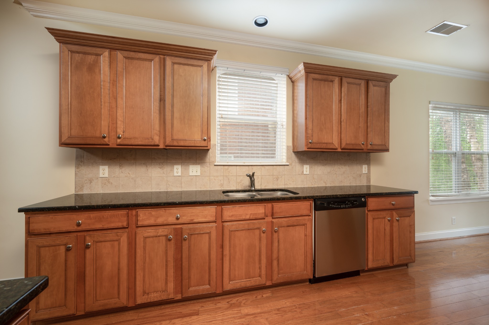 340 Wandering Circle Franklin, TN 37067 - Photo 20 of 51 a kitchen with granite countertop wooden cabinets stainless steel appliances a sink and a window