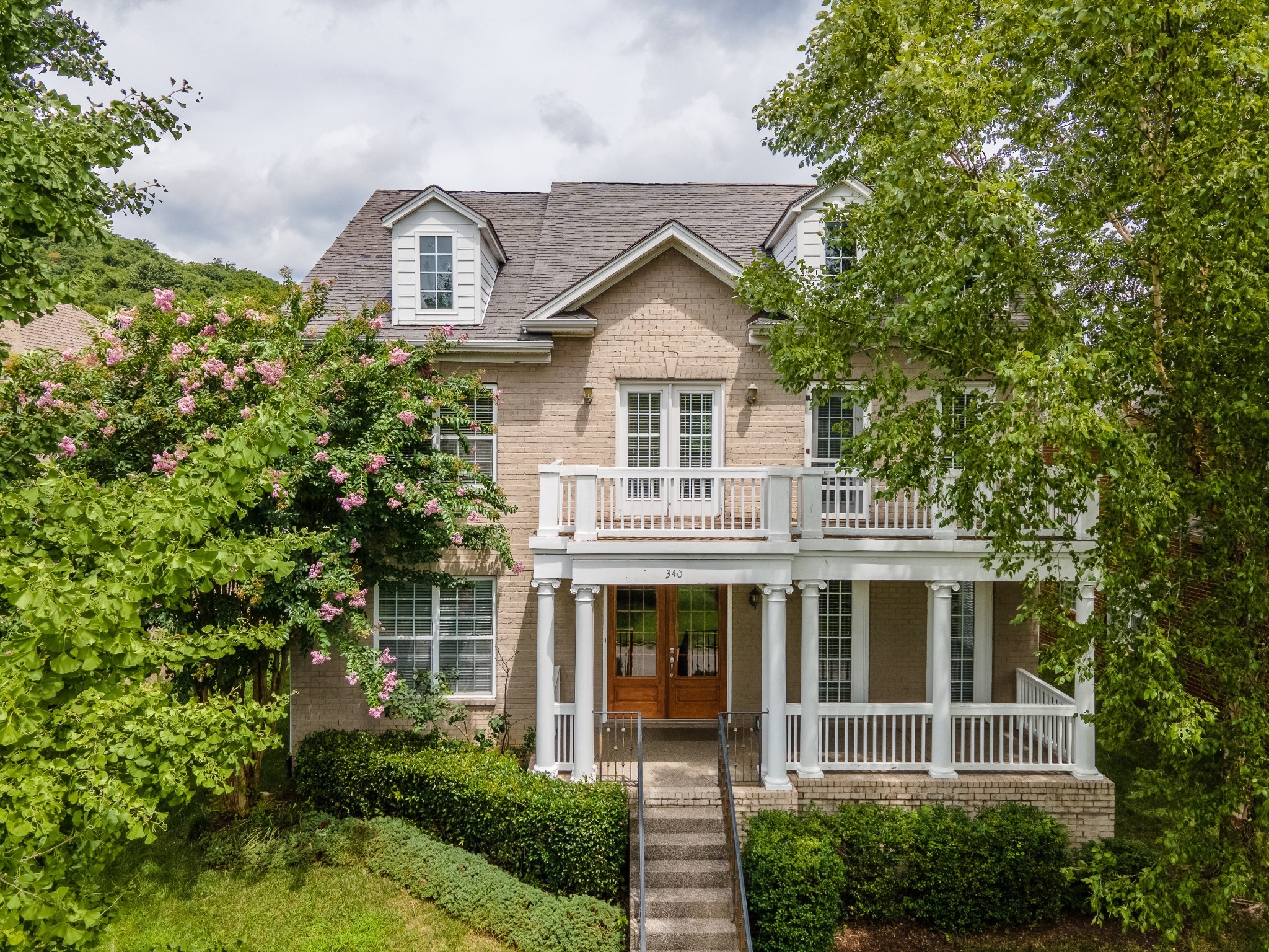340 Wandering Circle Franklin, TN 37067 - Photo 2 of 51 a front view of a house with a garden and plants