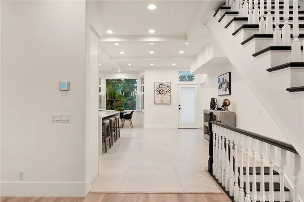 a view of a hallway with dining area and chandelier
