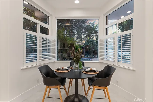 a view of a dining room with furniture and window
