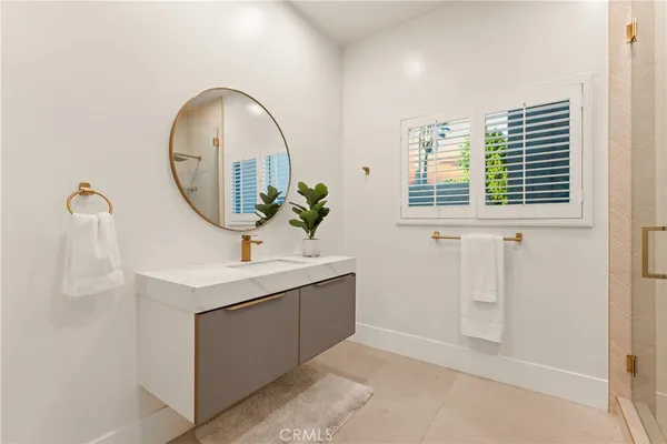a bathroom with a sink a mirror and window