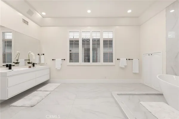 a spacious bathroom with a large tub and shower