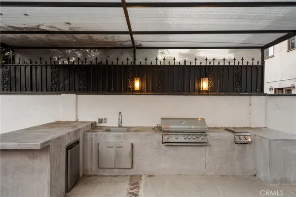 a kitchen with a sink a stove and cabinets