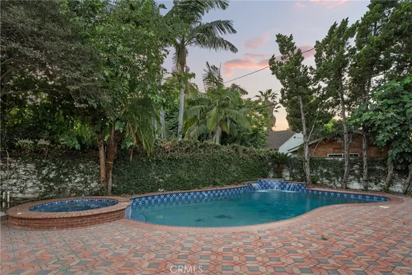 a view of a backyard with large trees