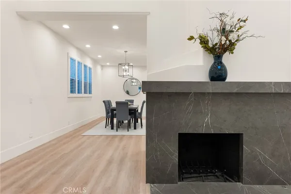 a view of living room with furniture and a fireplace