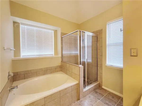 a bathroom with a bathtub and a shower