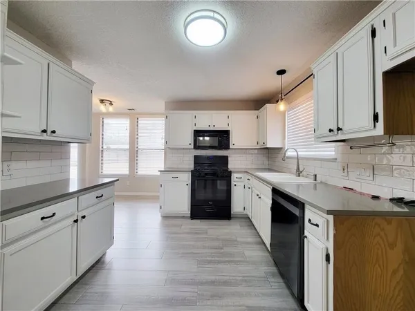 a view of a kitchen with electric appliances