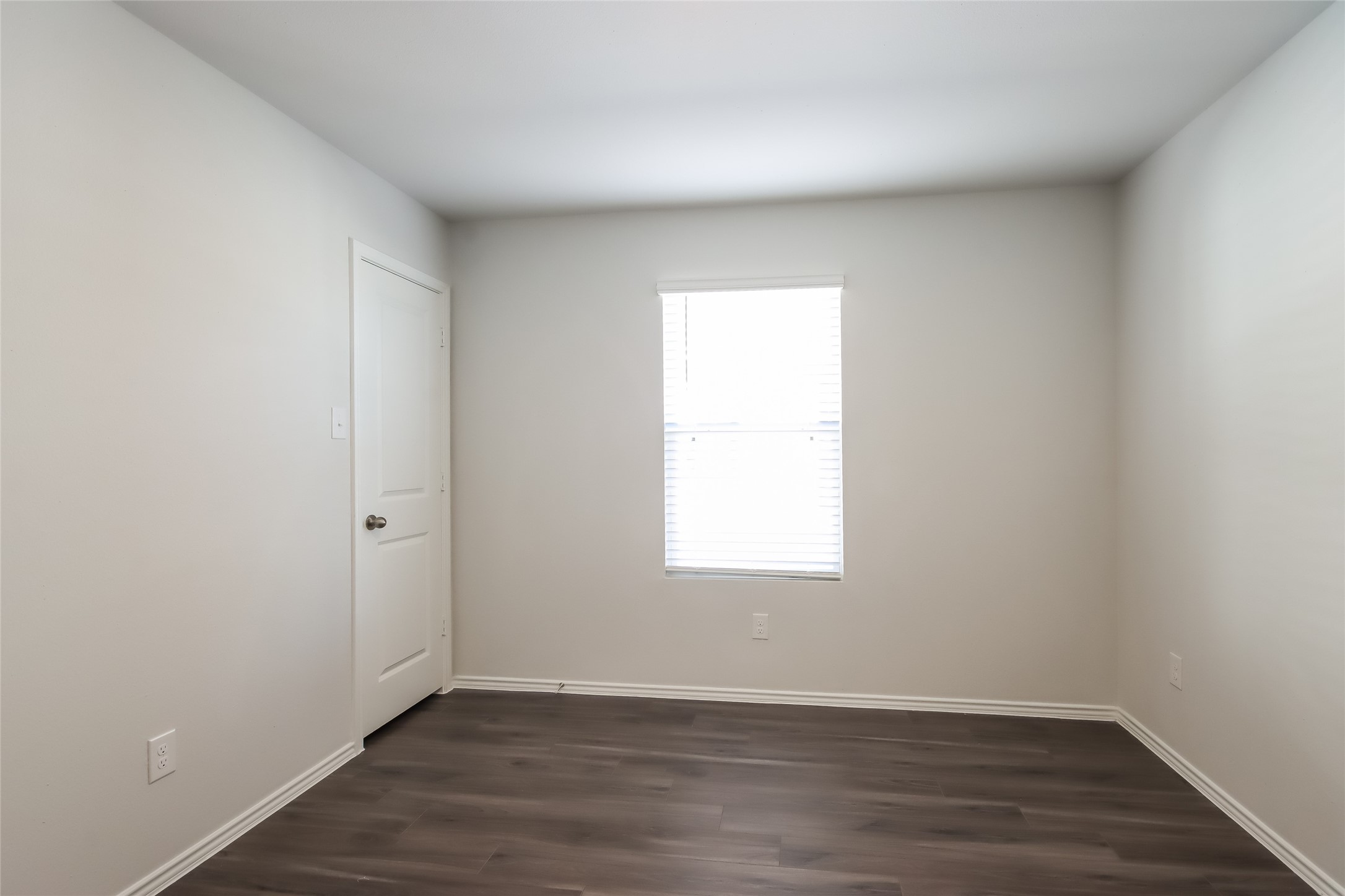 22419 Verdin Road Splendora, TX 77372 - Photo 12 of 17 an empty room with wooden floor and window