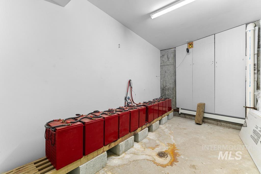 360 Lake Creek Riggins, ID 83549 - Photo 21 of 50 Misc room with unfinished concrete floors and a baseboard radiator