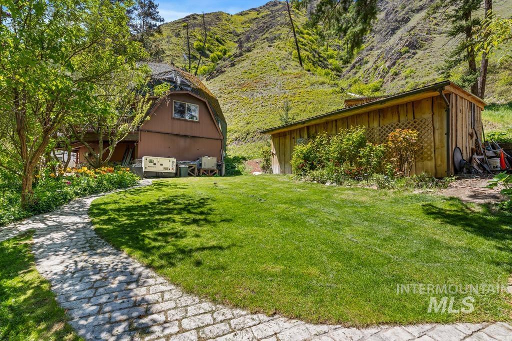 360 Lake Creek Riggins, ID 83549 - Photo 38 of 50 View of green lawn with an outdoor structure and a mountain view