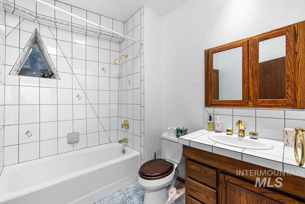 360 Lake Creek Riggins, ID 83549 - Photo 7 of 50 Full bathroom with vanity, shower / bath combination, tile patterned floors, and tasteful backsplash