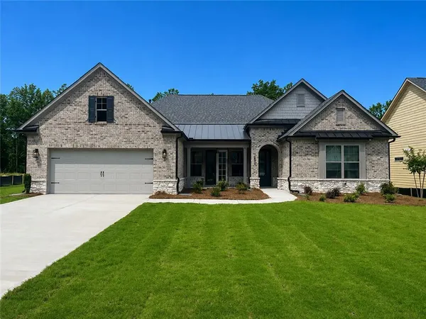 a front view of a house with swimming pool having outdoor seating
