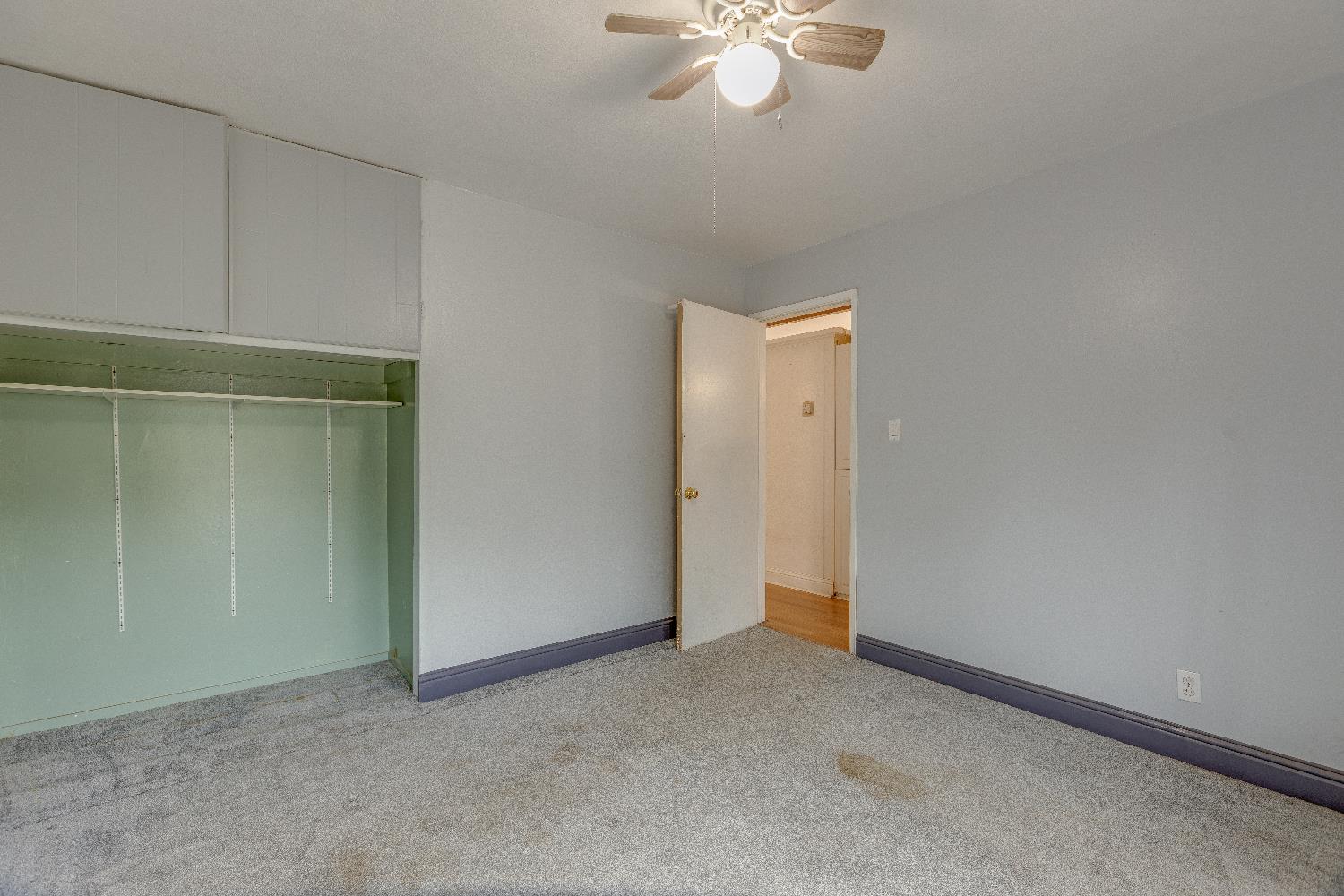 1570 East 26th Street Merced, CA 95340 - Photo 12 of 20 an empty room with a chandelier fan