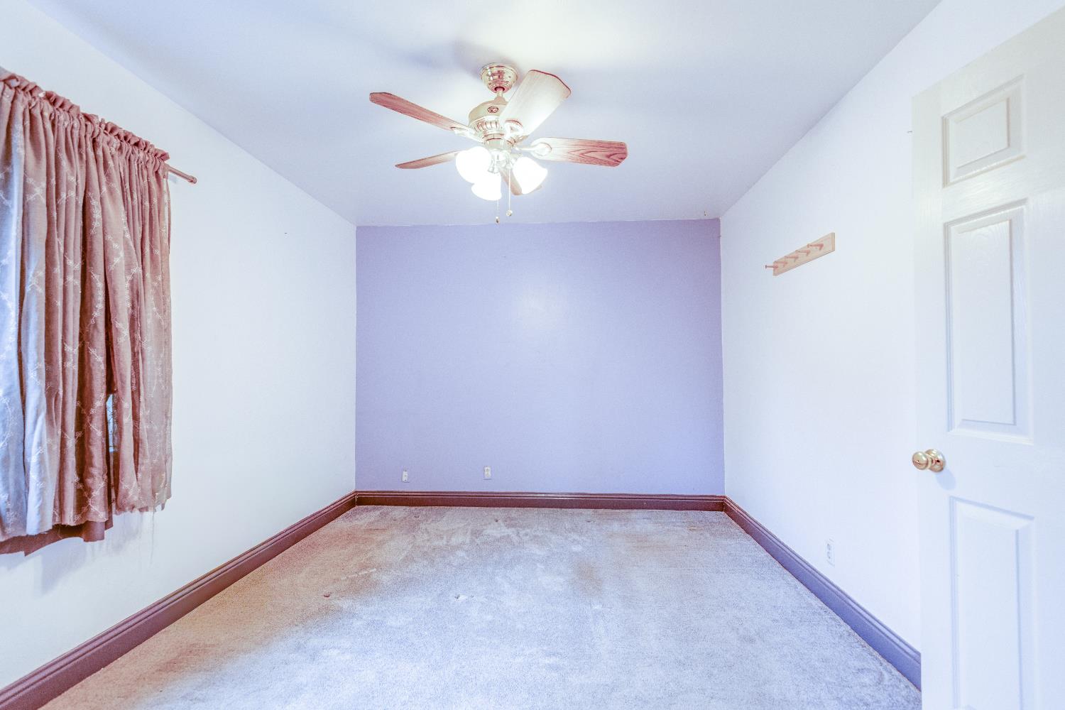 1570 East 26th Street Merced, CA 95340 - Photo 14 of 20 a view of an empty room with wooden floor and a window