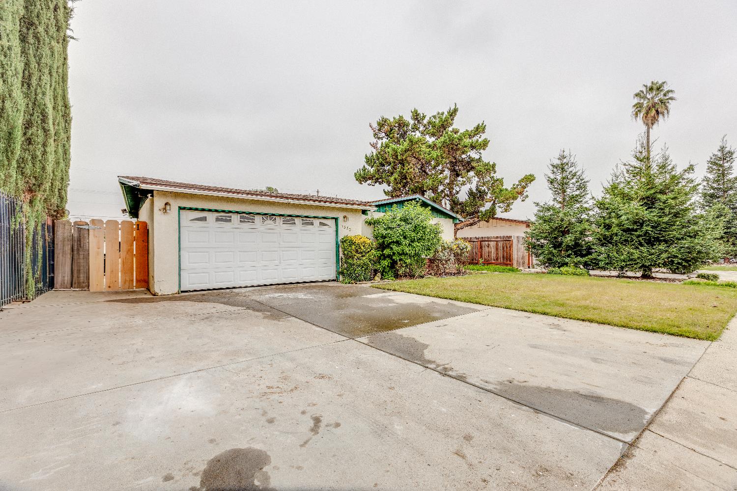 1570 East 26th Street Merced, CA 95340 - Photo 2 of 20 a front view of a house with a yard and garage