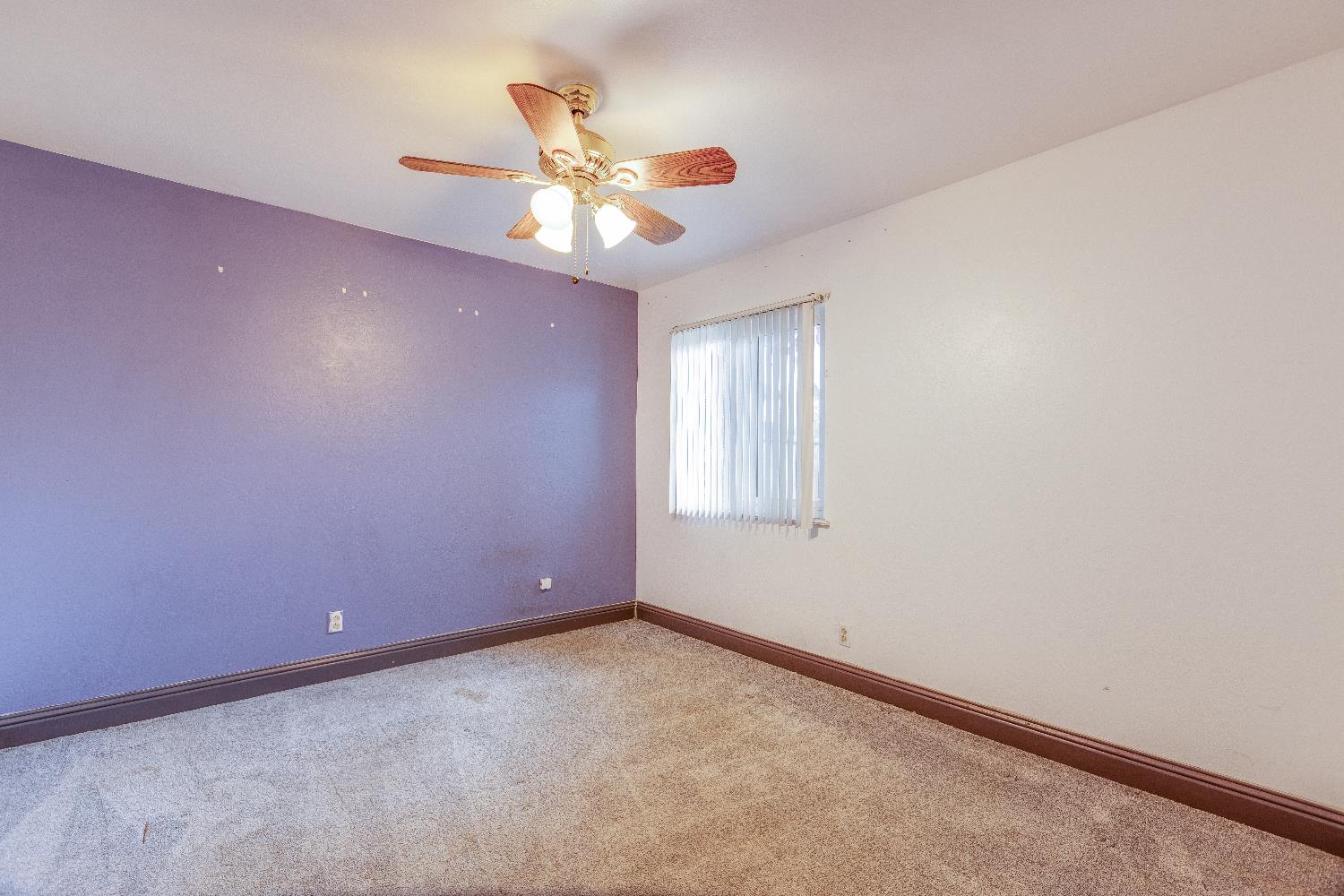 1570 East 26th Street Merced, CA 95340 - Photo 9 of 20 an empty room with windows and fan