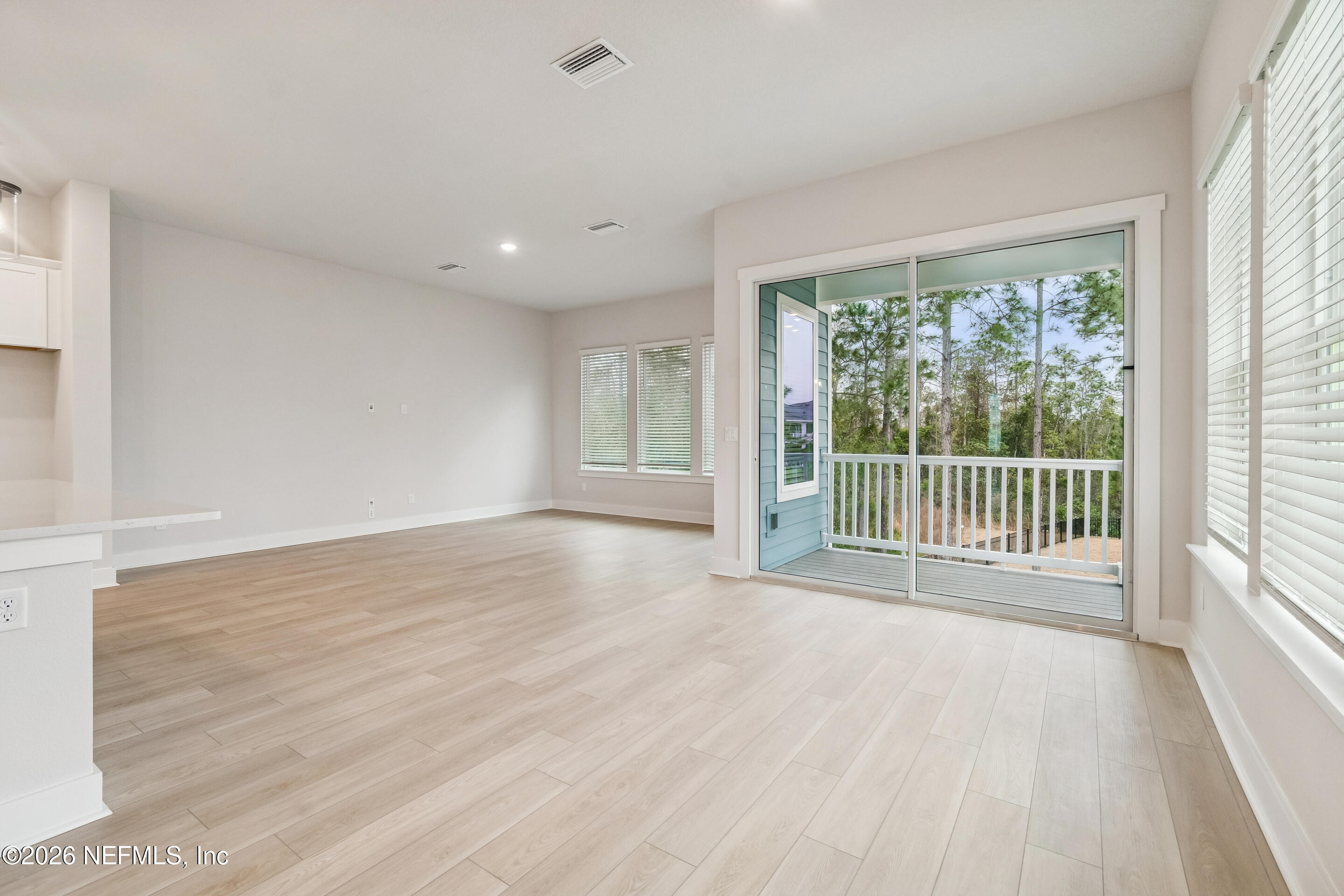 10165 Element Road Jacksonville, FL 32256 - Photo 14 of 25 a view of a room with wooden floor and windows