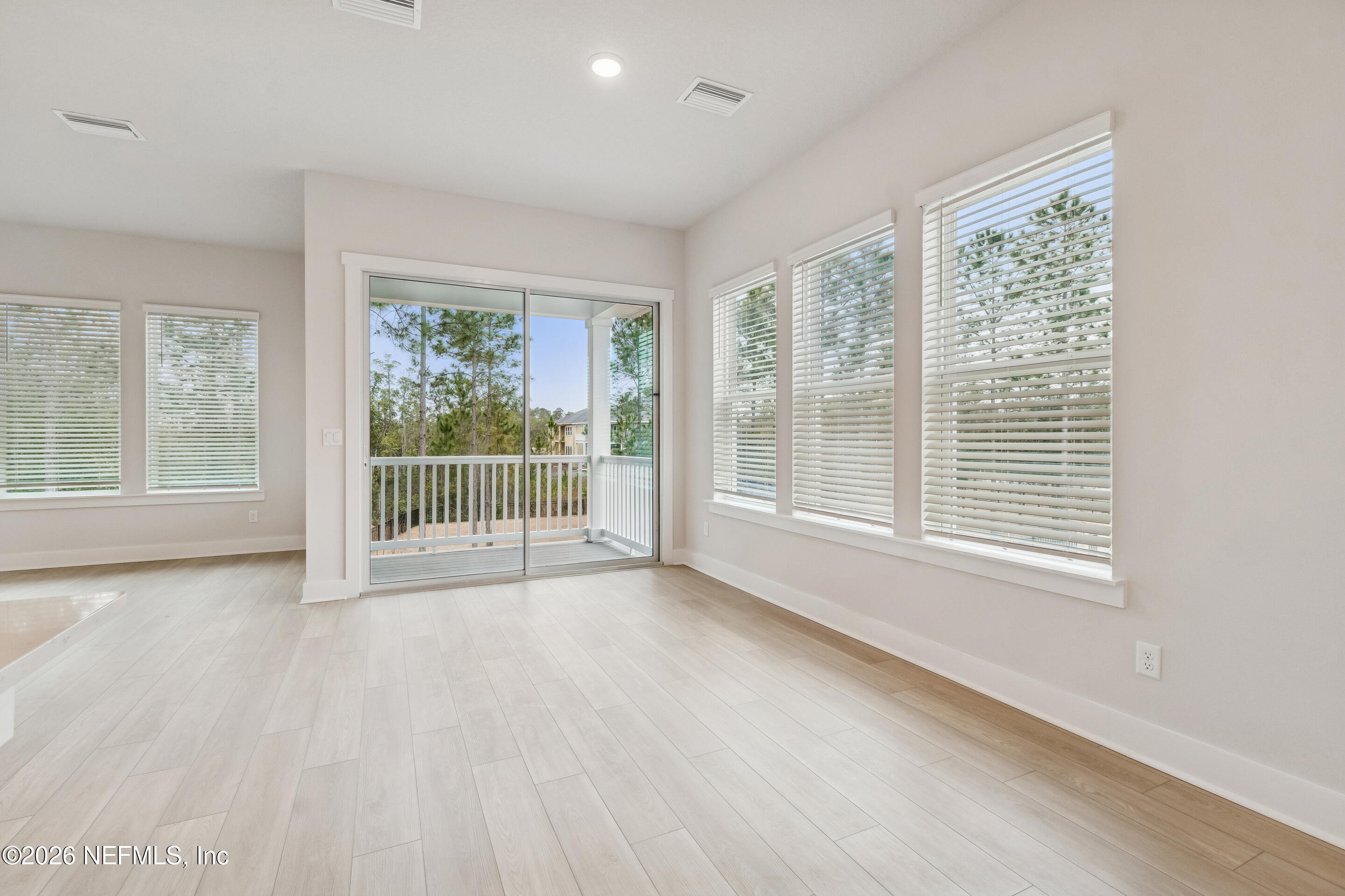 10165 Element Road Jacksonville, FL 32256 - Photo 15 of 25 a view of a room with wooden floor and windows