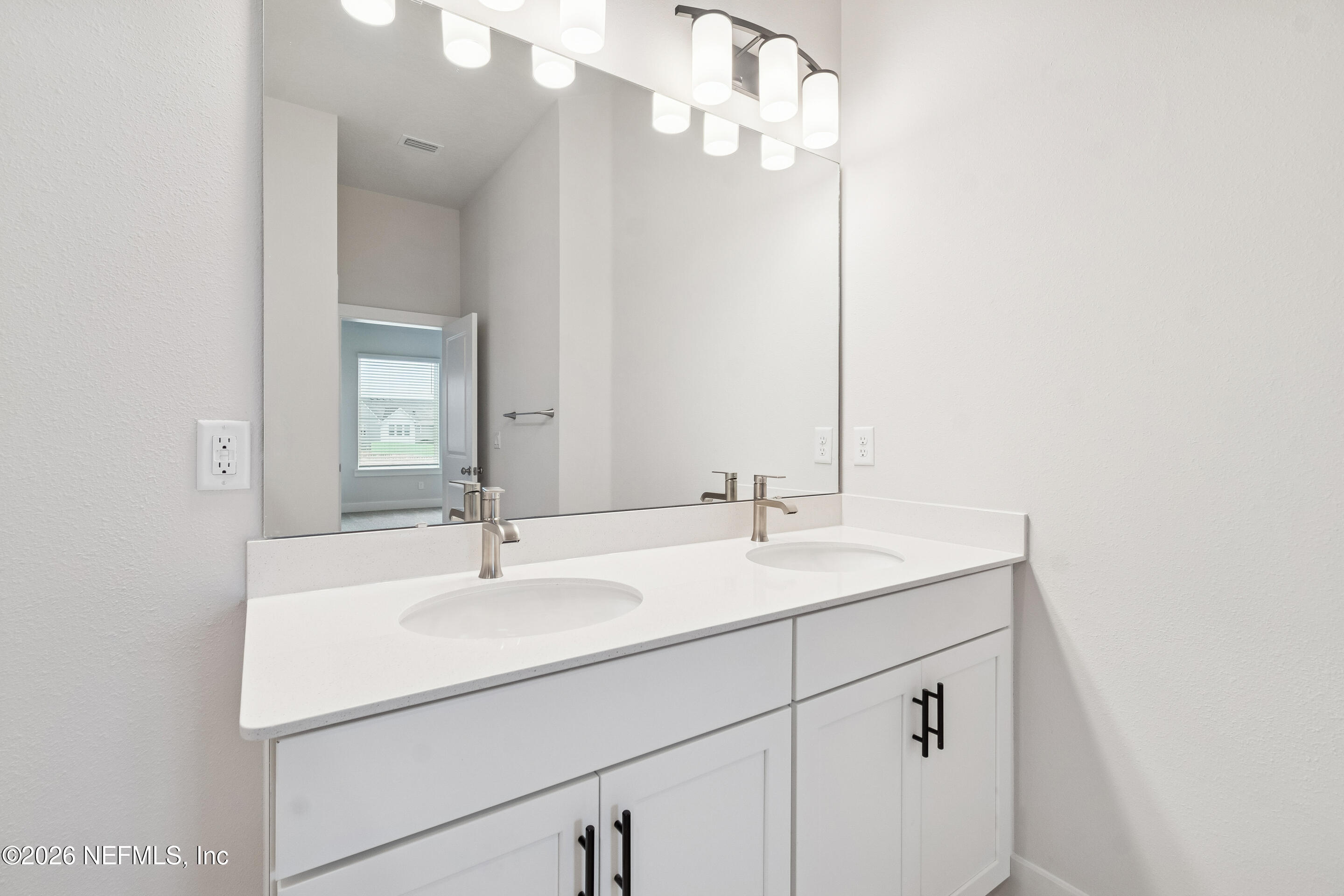 10165 Element Road Jacksonville, FL 32256 - Photo 24 of 25 a bathroom with a sink and a mirror