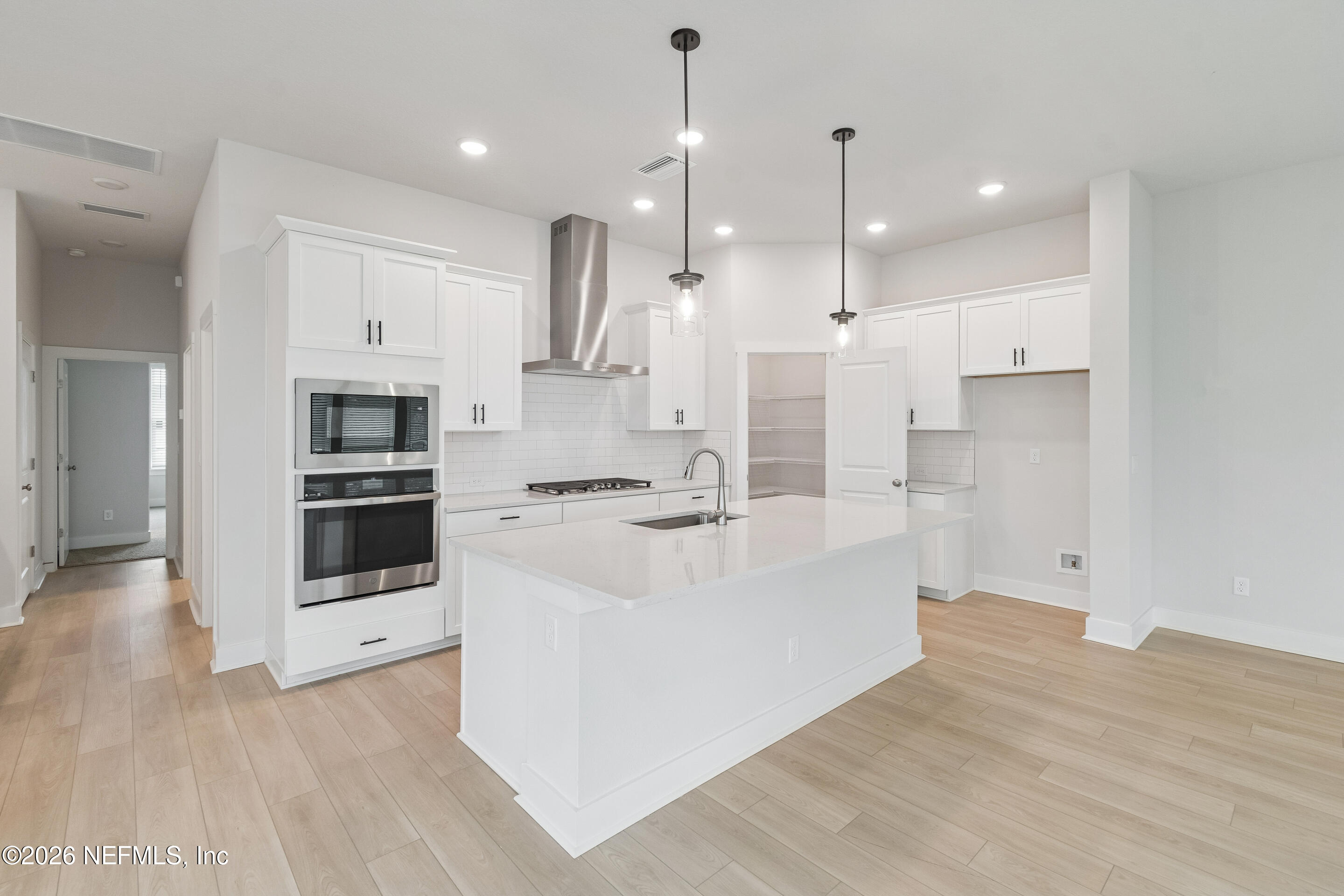10165 Element Road Jacksonville, FL 32256 - Photo 3 of 25 a large white kitchen with stainless steel appliances