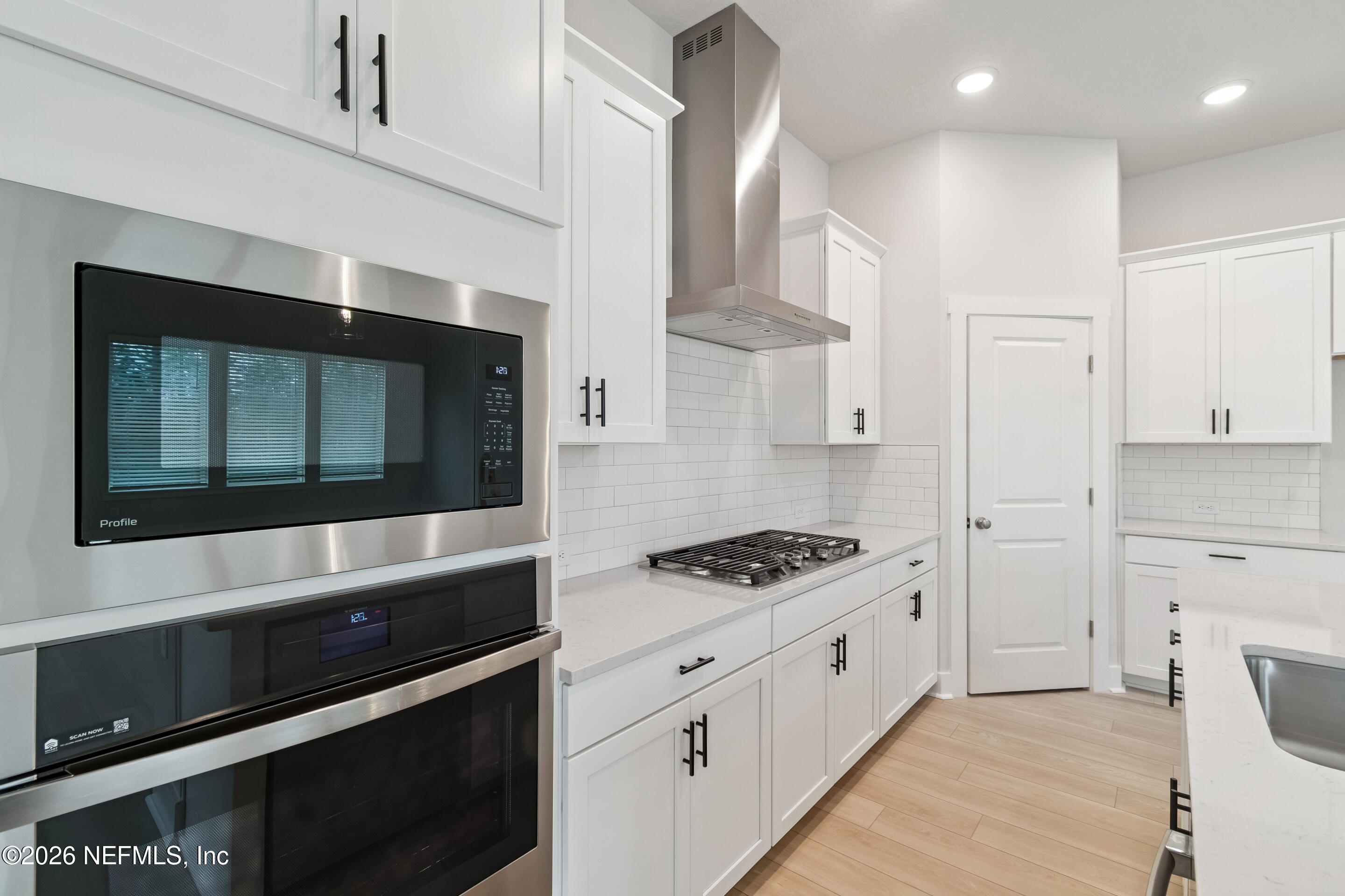 10165 Element Road Jacksonville, FL 32256 - Photo 7 of 25 a kitchen with stainless steel appliances kitchen island a stove and a microwave