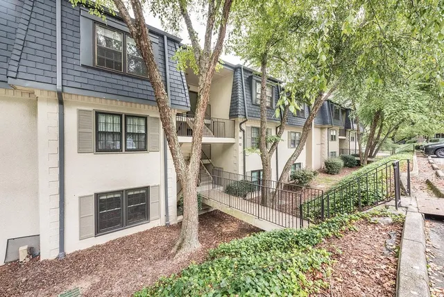 a view of a house with a yard and balcony