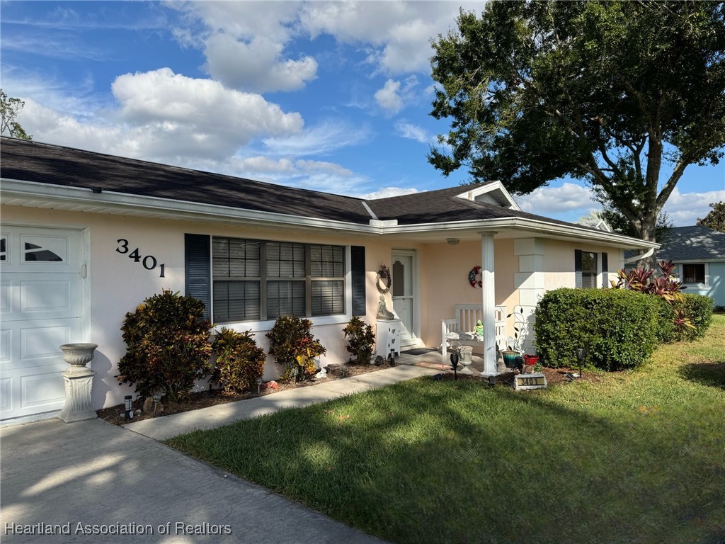 3401 Divot Road Sebring, FL 33872 - Photo 1 of 29 a front view of a house with a garden and plants