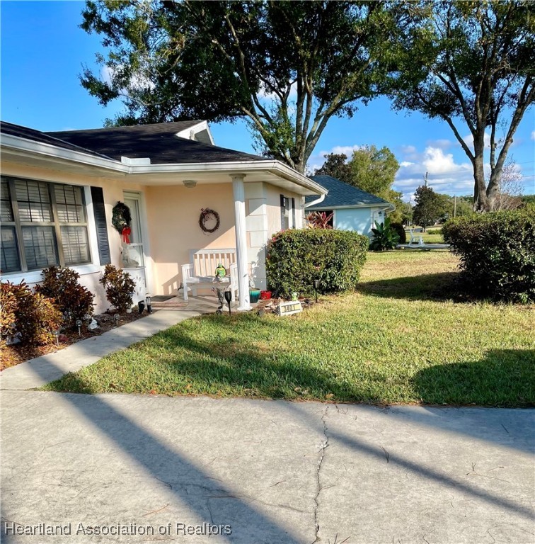 3401 Divot Road Sebring, FL 33872 - Photo 2 of 29 a front view of a house with a yard and potted plants