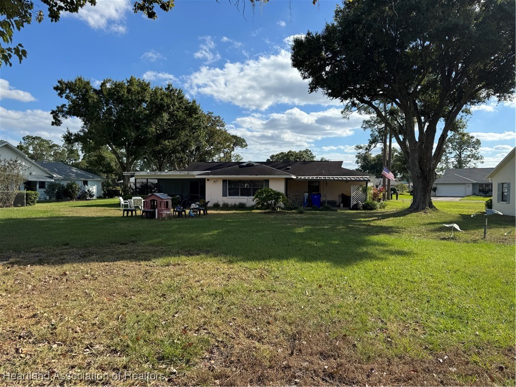 3401 Divot Road Sebring, FL 33872 - Photo 27 of 29 a front view of a house with a yard