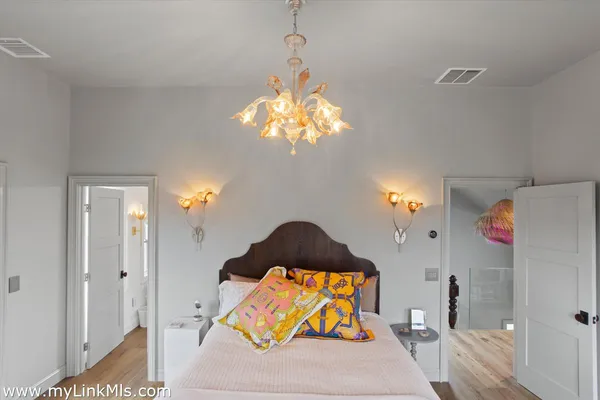 a bedroom with a bed dresser and a window