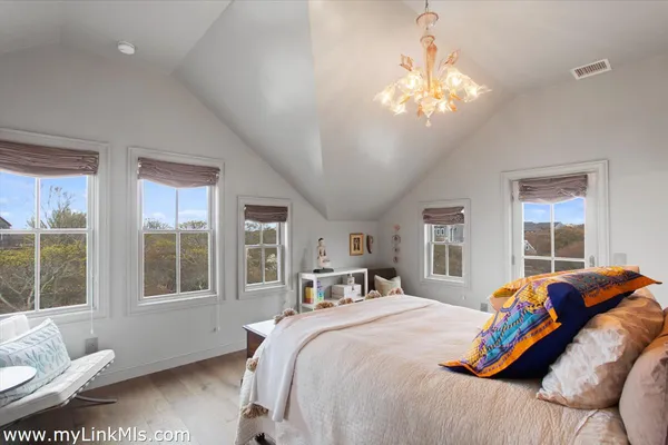 a bedroom with a large bed and a window