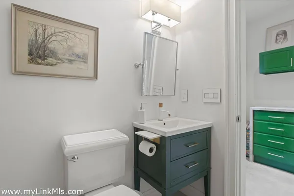 a bathroom with a toilet a sink and a mirror