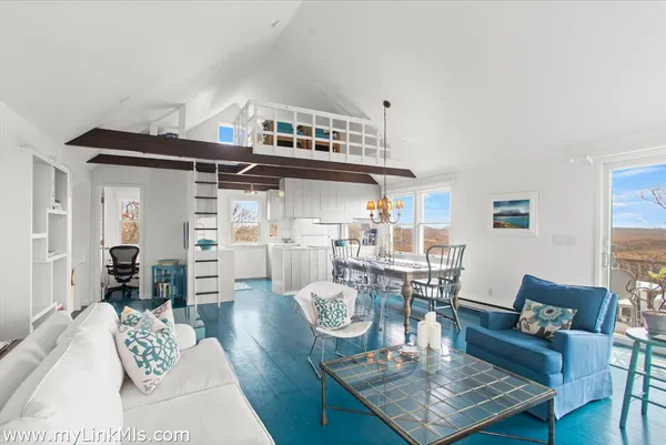 a living room with furniture and a dining table