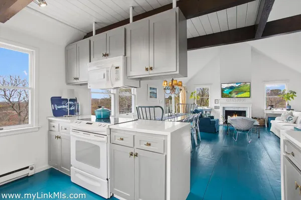 a kitchen with white cabinets and sink