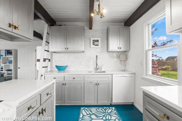 a kitchen with cabinets appliances and a window