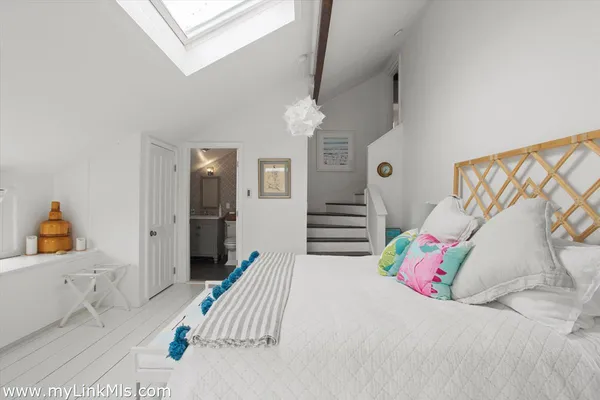 a bedroom with furniture and a chandelier
