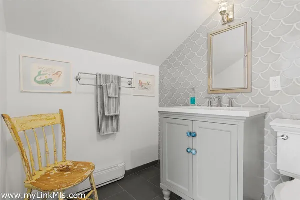 a bathroom with a sink mirror vanity and toilet