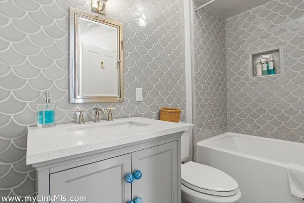 a bathroom with a sink a toilet and a bathtub