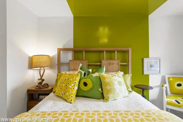 a bed room with a bed and a lamp