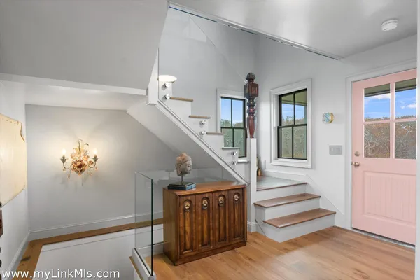 a view of entryway and hall with wooden floor